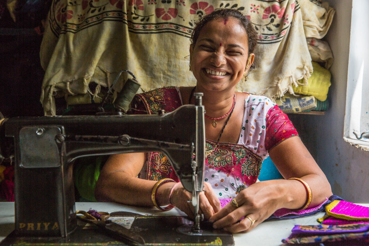 Female entrepreneur making handmade purses in her home. Photo: Paula Bronstein / Images of Empowerment.