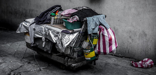 Cart with collected items on the street. Photo by Gio Almonte on Unsplash